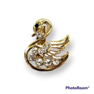 Gold tone swan pin with rhinestone accents